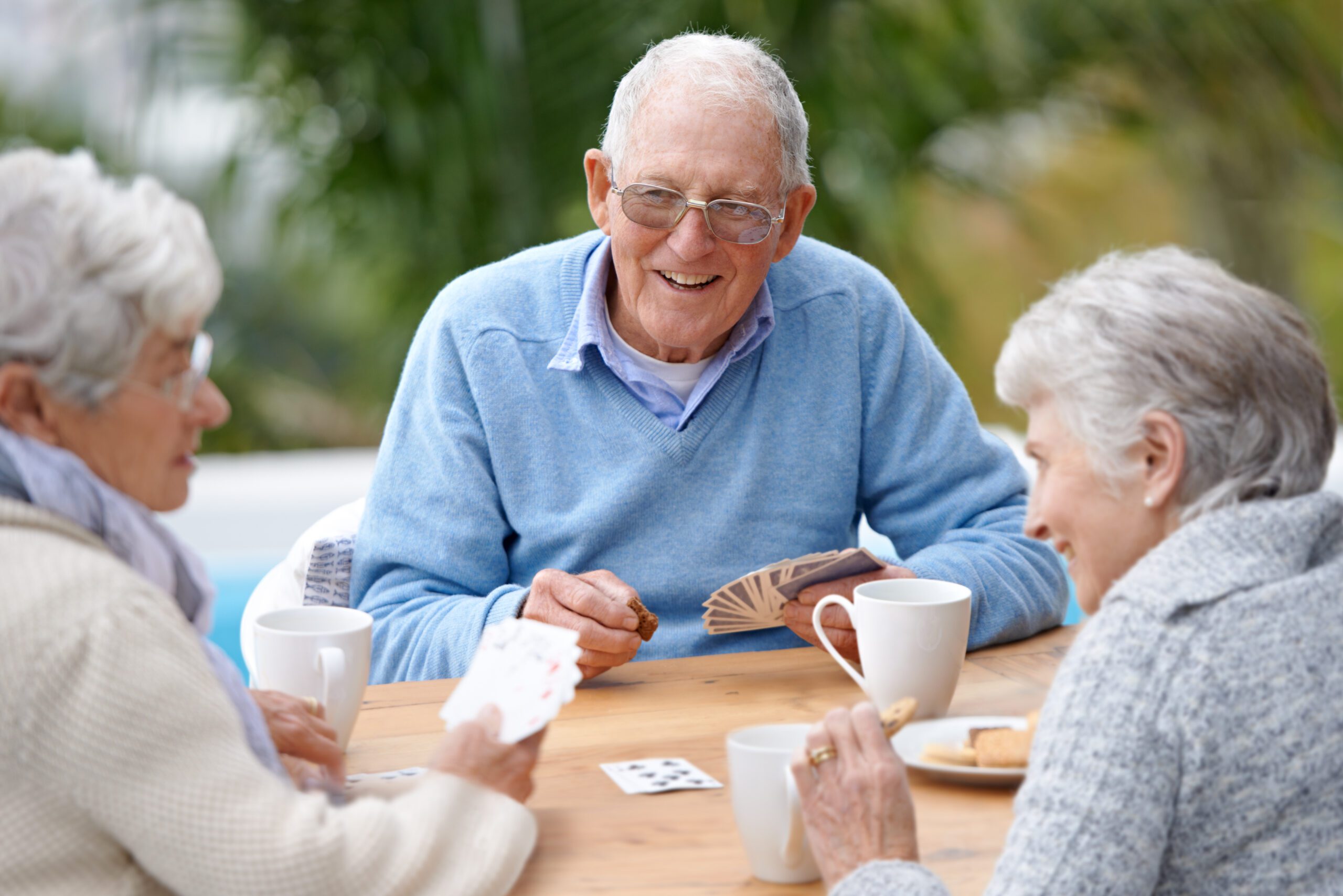 A group of senior citizens playing cards together.