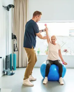 Senior working with physical therapist